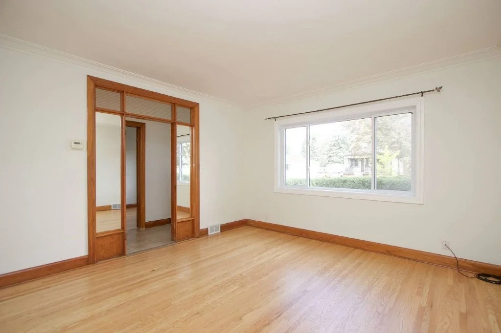 Sunlit living room with red oak floors